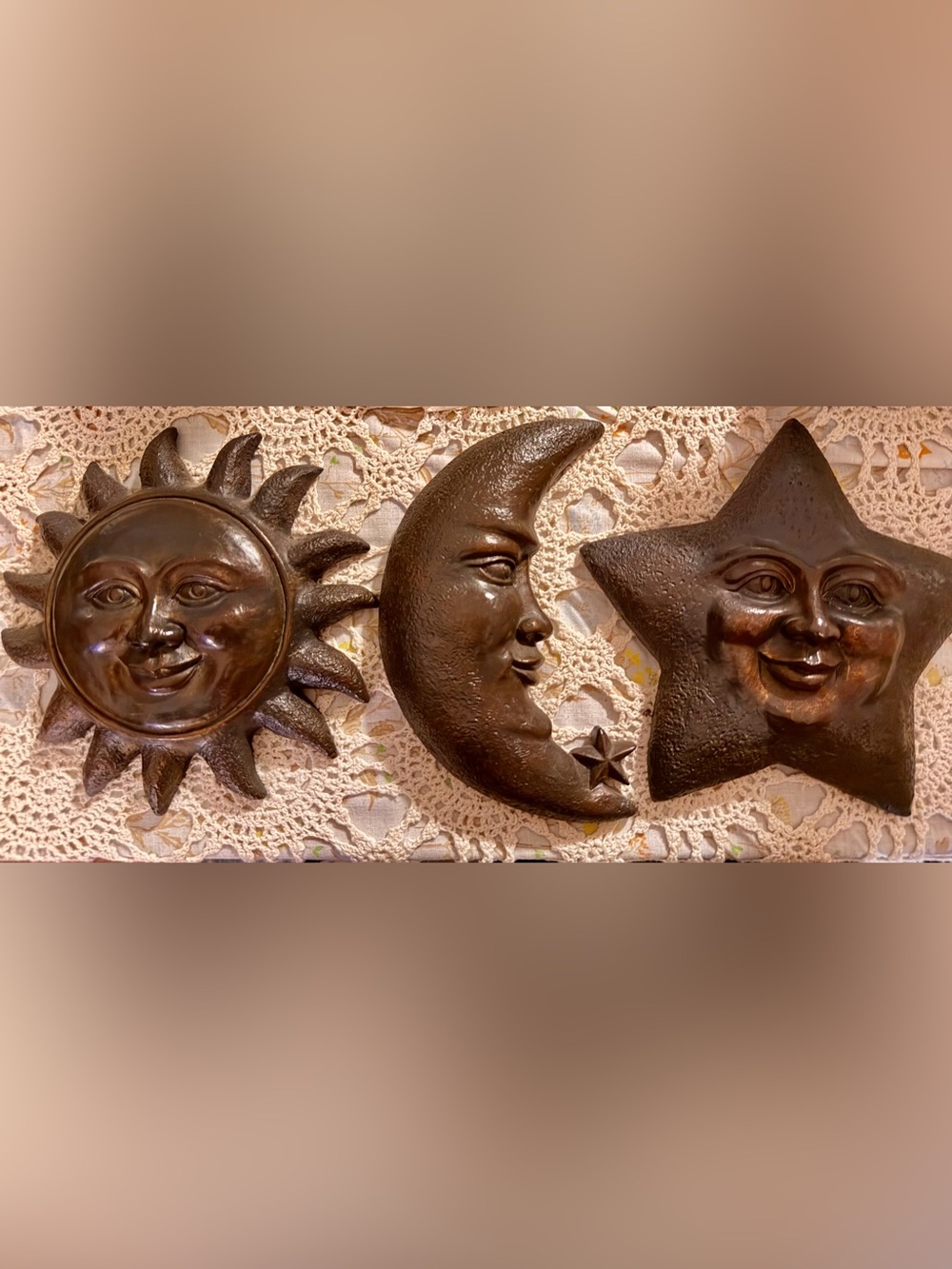 Vintage celestial wall plaques featuring a sun, moon, and star design.